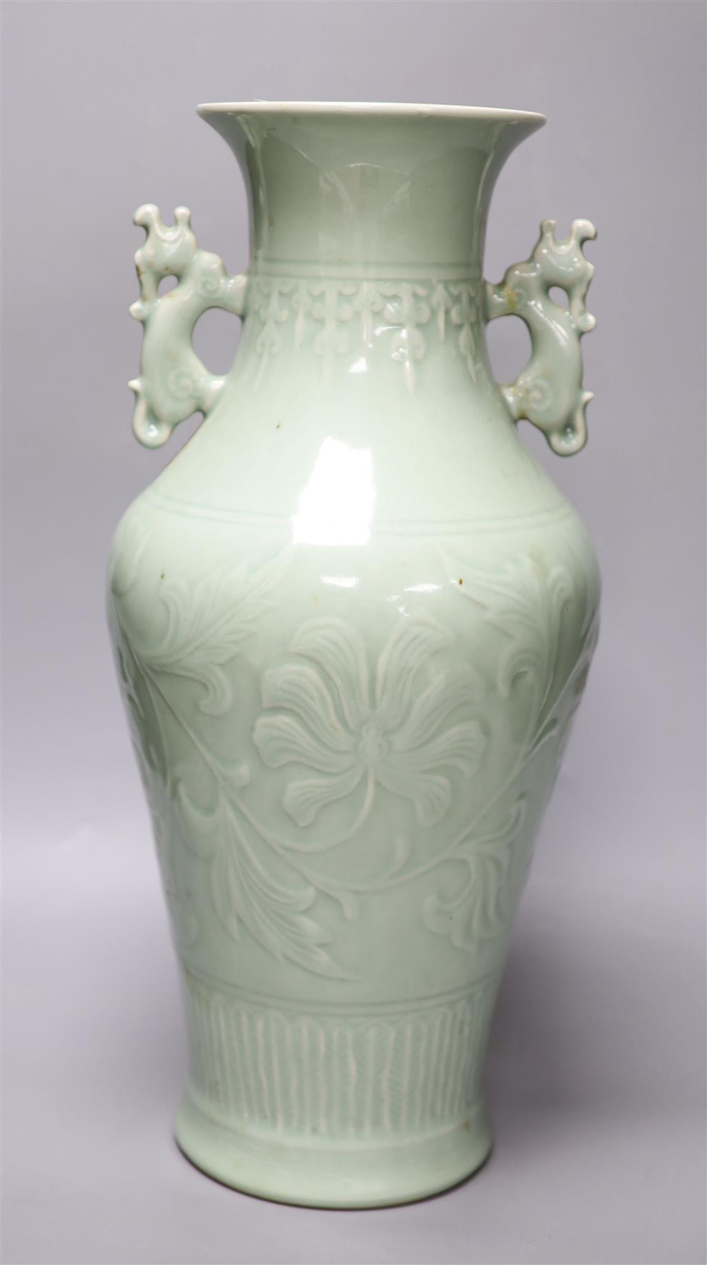 A Chinese green celadon glazed vase, with dragon handles, height 44cm (one re-glued handle)